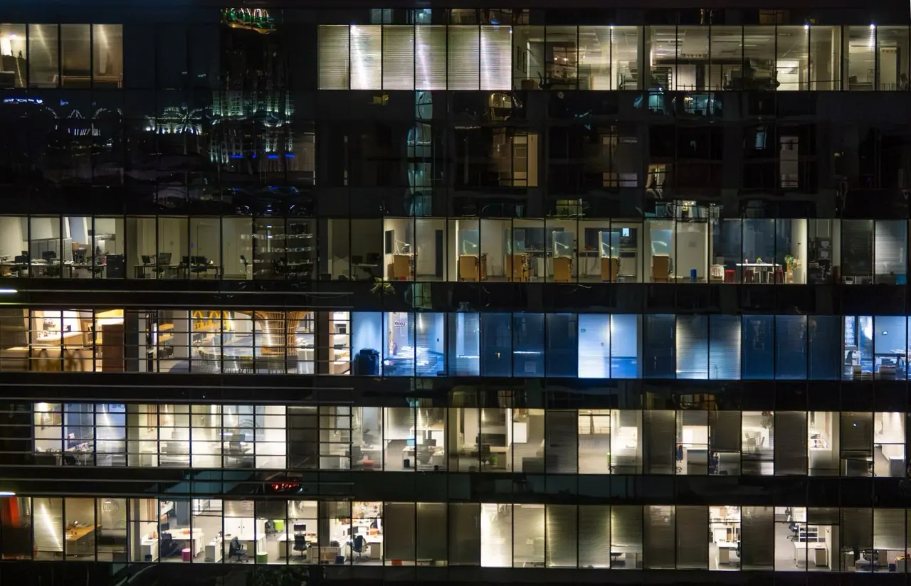 Office tower at night with lit floors